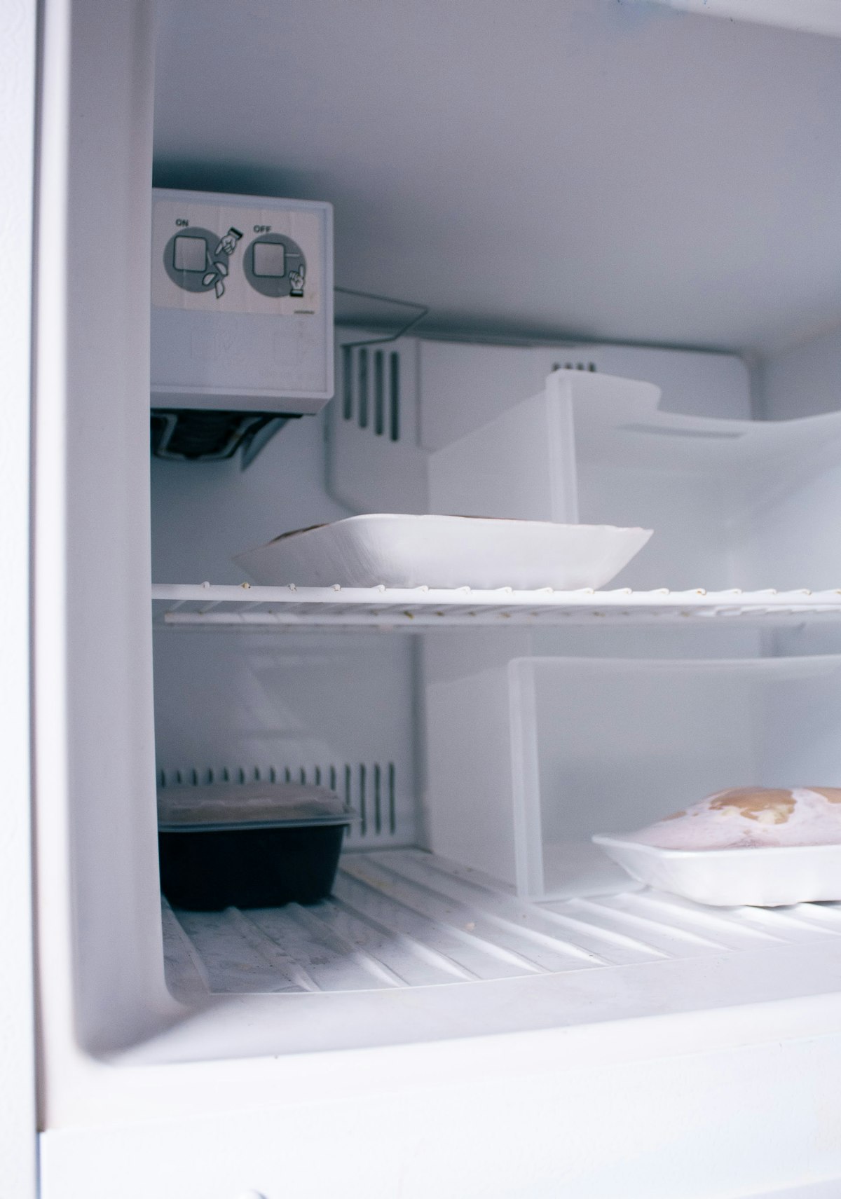 Open commercial freezer unit stocked with frozen product after servicing